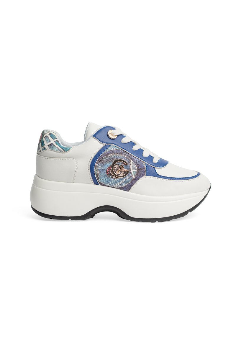 White leather sneaker with blue accents, textured design, thick white sole, and embroidered detail featuring a circular pattern and logo.