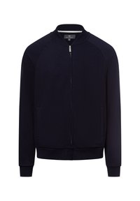 Navy zip-upjack met een gladde stof. Kenmerken zijn raglanmouwen, een geribbelde kraag, zijzakken en een fitted zoom met elastische manchetten.