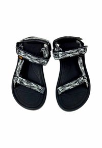 Musta sandaalit, joissa on teksturoitu pohja, varustettu säädettävillä kuvioiduilla hihnoilla harmaan ja valkoisen sävyissä, suunniteltu mukavuutta ja vakautta varten.