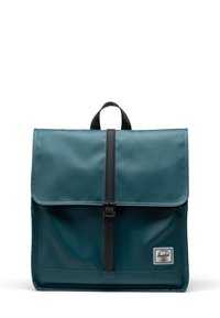 Teal backpack made of durable material, featuring a flap closure secured with a black strap, and a branded patch at the bottom corner.