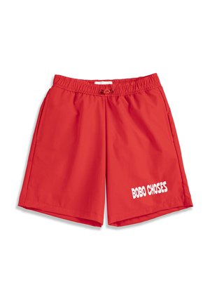 Czerwone szorty z elastycznym pasem i sznurkiem oraz bocznymi kieszeniami, z białym napisem „BOBO CHOSES” na dolnej prawej nogawce.