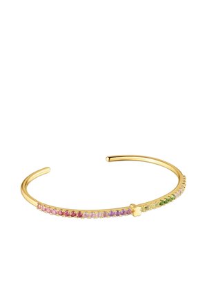 Bracciale rigido aperto in oro con una fila di piccoli gemme multicolori e un piccolo accento a forma di fiore in oro al centro.
