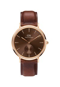 Brown leather strap watch with a rose gold case, a brown dial, slim gold hands, and a circular subdial. Minimalist hour markers.
