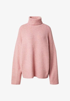 Pull en col roulé surdimensionné de couleur rose, réalisé en tissu tricoté doux, avec des détails côtelés au niveau du col et des poignets pour une texture supplémentaire.