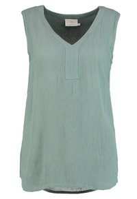 Haut sans manches vert menthe avec un col en V, un tissu texturé et une coupe ample, doté d'un subtil pli à l'encolure.