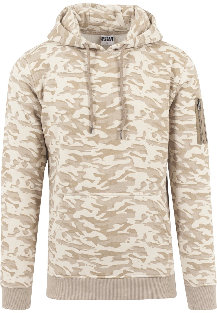 Beige camouflasjehette med snøring, kengurulomme og glidelåslomme på ermene. Laget av mykt stoff, med ribbestrikkede mansjetter og hem.