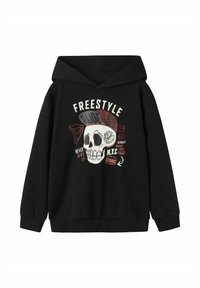 Sweat à capuche noir avec un graphique de crâne et du texte. Le design inclut des icônes de nourriture colorées et des phrases, avec une coupe décontractée et des poignets côtelés.