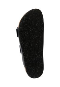 Semelle en caoutchouc noir avec des motifs de grip texturés, dotée d'un bord en liège et de deux brides réglables sur le côté pour un maintien sécurisé.