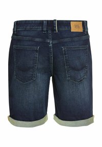 Shorts en denim bleu foncé avec des ourlets roulés, présentant une étiquette en cuir beige à l'arrière à la taille et deux poches arrière avec des coutures courbes.