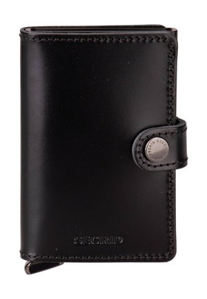 Black leather Secrid wallet with snap button closure and visible stitching around edges.