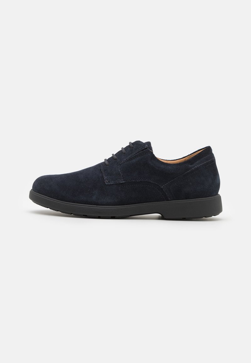 Chaussure à lacets en daim bleu foncé avec semelle noire, petit talon et bout arrondi, vue de côté externe sur un fond blanc uni.