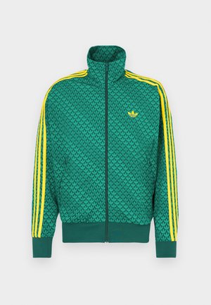 Roheline lukkuga jakk geomeetrilise mustriga, kollaste triipudega varrukatel, kõrge krae ja rinnal logo. Kerge kangas.