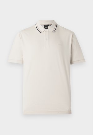 Polo majica v off-white bombažu, z dvema gumboma, ovratnik z črnimi in rdečimi črtami ter diskretno vezenje logotipa na prsih.