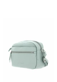 Sac bandoulière en cuir vert clair avec surface texturée, comprenant une poche zippée à l'avant et une sangle réglable. Logo embossé sur le devant.