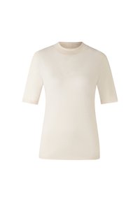 Krémový top s krátkým rukávem a vysokým límcem, vyrobený z měkké, hladké tkaniny. Jednoduchý design bez viditelných vzorů nebo akcentů.