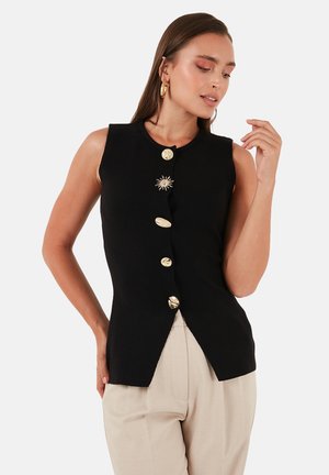 Schwarzes ärmelloses Top mit goldenen Knöpfen und einer sternförmigen Verzierung, slim fit und einem abgerundeten Saum.