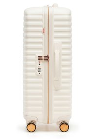 Hard-shell white suitcase with textured ridges, rose gold zipper and lock, side handle, and four rose gold-accented spinner wheels.