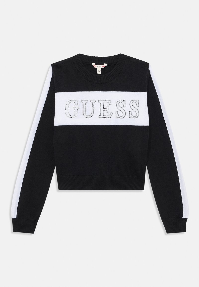 Svart tröja med ett vitt rand och ordet "GUESS" i silverbroderi över bröstet. Rund halsringning, långa ärmar och ribbad nederkant.