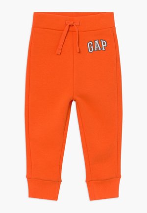 Pantalon de survêtement pour tout-petit de couleur orange vif avec poignets et taille côtelés, cordon de serrage ajustable, et logo "GAP" brodé près de la poche avant.