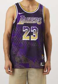 Fioletowy strój koszykarski z żółtymi akcentami, napis "LAKERS", numer gracza 23, wzór w kropki i metka z logo NBA na dole.