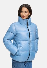Light blue puffer jacket with a high collar, quilted design, side pockets, and a black zipper. Smooth texture and a relaxed fit.
