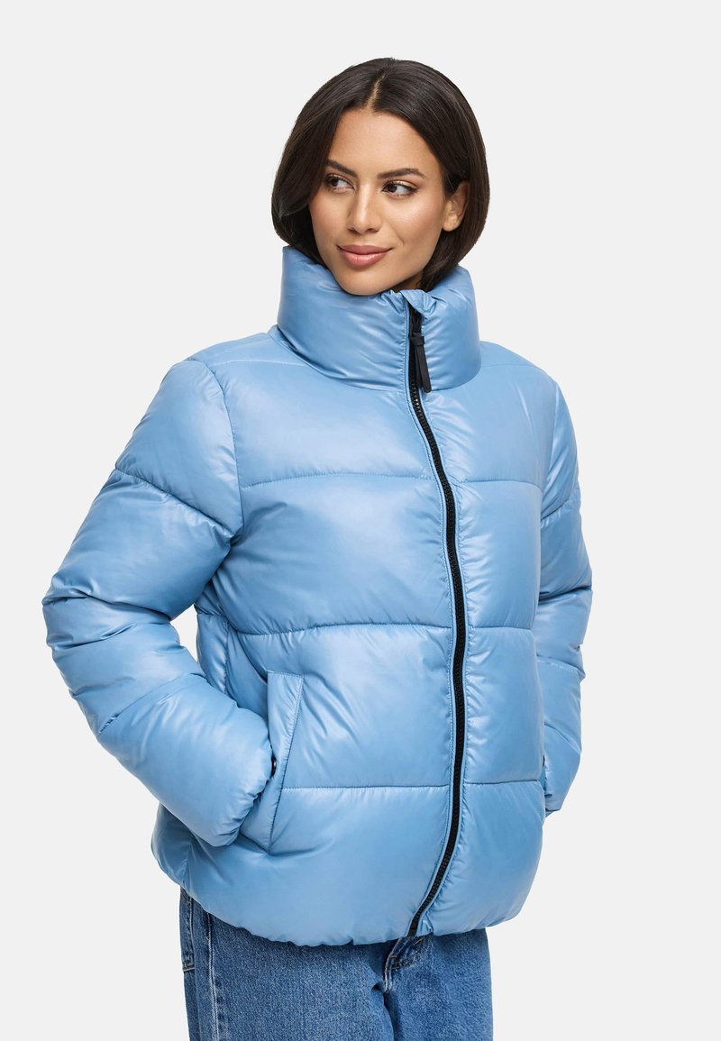 Light blue puffer jacket with a high collar, quilted design, side pockets, and a black zipper. Smooth texture and a relaxed fit.