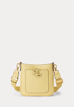 Sárga bőr keresztpántos táska állítható pánttal és aranyszínű RL logóval az első zsebén, homogén háttér előtt.