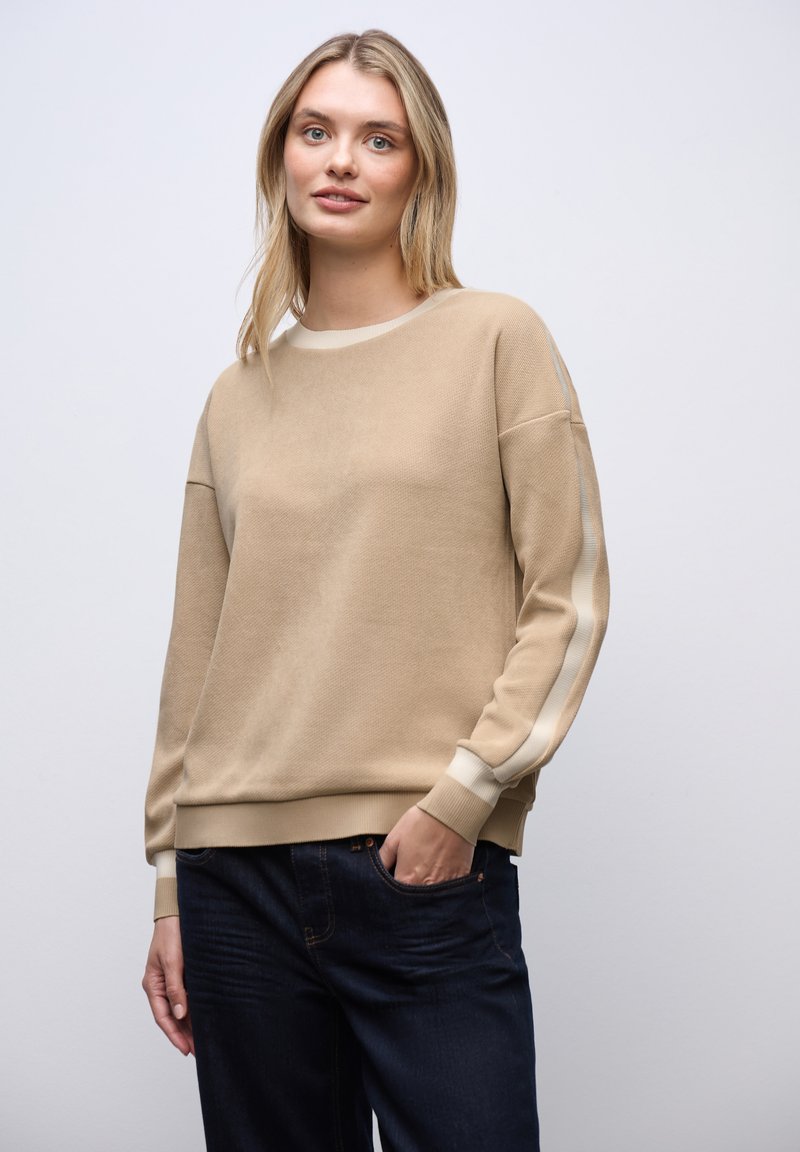 Sudadera de cuello redondo beige con tejido texturizado, rayas en off-white contrastantes a lo largo de las mangas y puños y dobladillo de canalé.