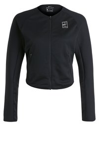 Chaqueta negra Nike Dri-FIT con cremallera, de mangas largas, con dos bolsillos con cremallera y un logo blanco de cancha de tenis en el pecho.