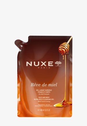 NUXE Rêve de miel Gesichts- und Körperreinigungs-Gel mit Honiglöffel, der Honig tropft, 400 ml für trockene Haut.