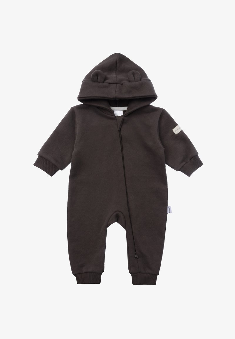 Brown fleece onesie with bear ears on hoodie, front zipper, ribbed cuffs, and a small label on the left sleeve. Soft, warm fabric.
