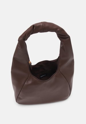 Braune weiche Lederhandtasche mit gedrehtem Griff und teilweise offenem Reißverschluss, der das Innenfach vor hellem Hintergrund zeigt.