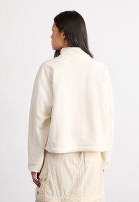 New Balance GRAPHIC POLAR HALF ZIP - Sweat polaire - beige