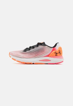 Sport shoes in pink and gray mesh with black laces and orange accents. Features a cushioned sole and ergonomic design.