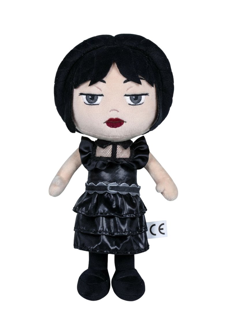 Poupée en peluche noire avec une jupe superposée à volants, un détail en maille et des traits du visage cousus. Cheveux courts noirs et chaussures noires. Étiquette avec marquage CE.