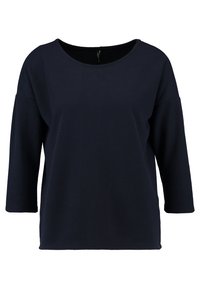 Marinblå kortärmad topp med rundad halsringning, strukturerad tyg och löst mode. Har sänkta axlar och en avslappnad siluett.