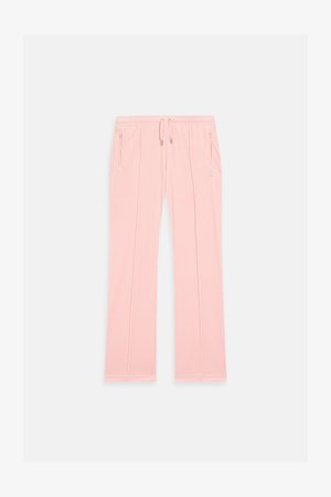 Pantalons de survêtement rose clair en tissu doux, dotés d'une taille élastique à cordon de serrage, de poches zippées sur les côtés et de détails de couture subtils le long des jambes.