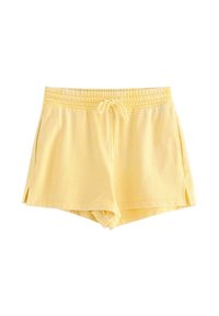 Pantaloni corti gialli in tessuto morbido con cintura elastica, cordino e spacchi laterali per facilitare il movimento. Design casual.