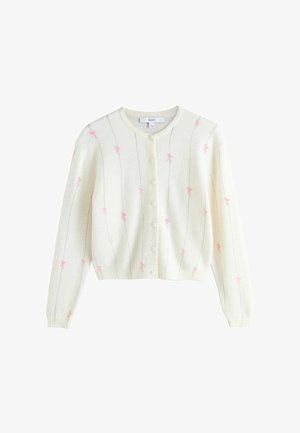 Krém színű, hosszú ujjú gombos kardigán, melyen vékony függőleges vonalak és apró rózsaszín masni minták találhatók.