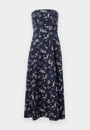 Vestido sin tirantes de color navy con falda acampanada, que presenta un patrón floral y de objetos en blanco en toda su superficie. Fabricado en tejido ligero.