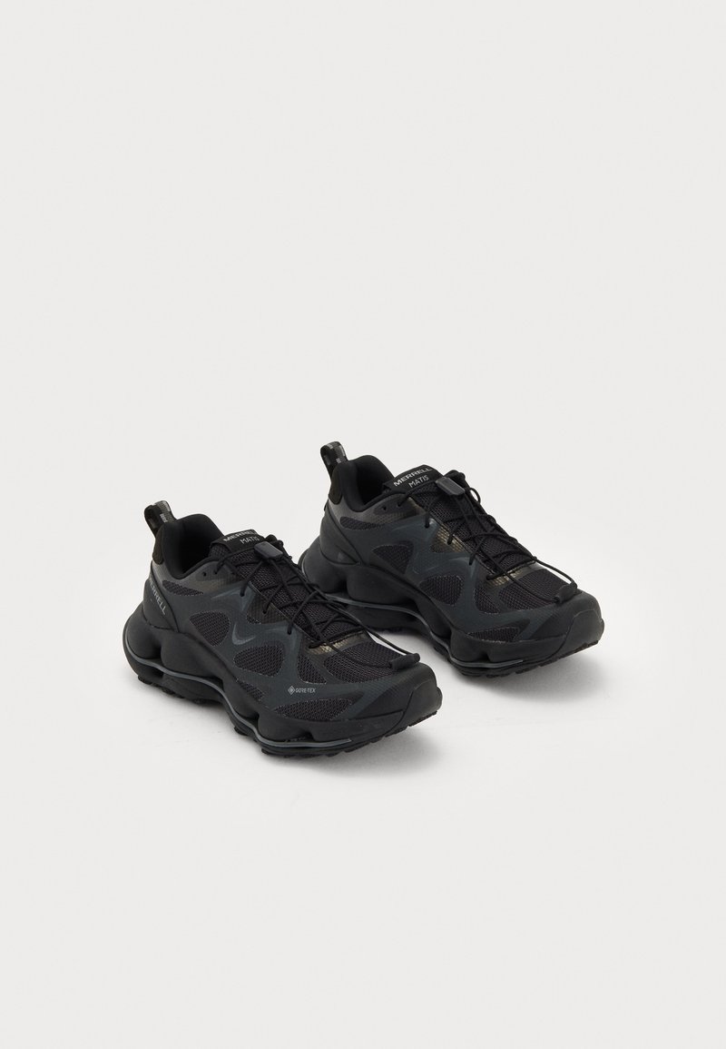 Black athletic shoes with a mesh upper and textured overlays, featuring a cushioned sole and lace-up design, with pull tabs on the heel.