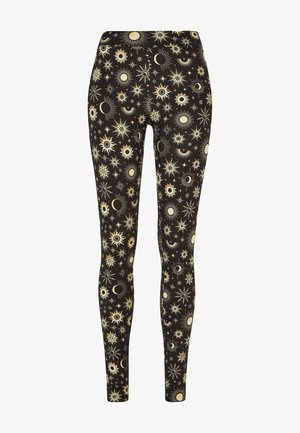 Zwarte leggings met een hemels patroon van zonnen, manen en sterren in crème. Rekbare stof, aansluitend ontwerp en een gladde textuur.