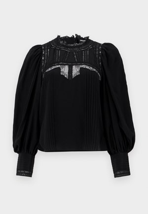 Melna blūze ar augstu mežģīņu apkakli, plecu priekšpusi un puffētiem piedurknēm. Mežģīņu akcenti kakla izgriezumā un aprocēs piešķir detaļu. Gluda tekstūra.