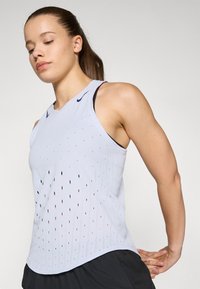Lichtblauw sportief tanktop met geperforeerd patroon, ronde halslijn, mouwloos ontwerp en subtiele merklogo op de schouder.
