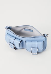 Sky blue leather handbag with zip closure, featuring two front pouches, silver hardware accents, and a smooth textured interior.