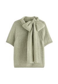 Stickad kortärmad tröja i ljusgrön med en strukturerad yta, med ett stort flugband vid halsen och en rundad krage.