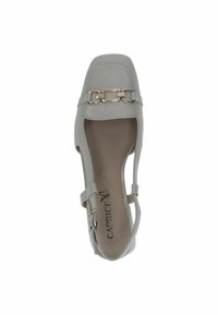 Graue Kunstlederflatschuhe mit offenen Seiten, eckiger Zehenpartie und einem dekorativen metallischen Schnallenakzent am Riemen. Das Innere ist hell gefärbt.