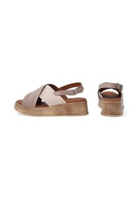 Beige and taupe wedge sandals with crossed straps, adjustable ankle strap, and wood-textured platform. Smooth leather and rubber sole.