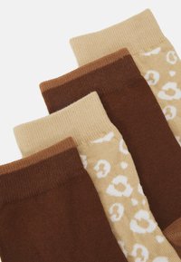 Conjunto de três meias em tons de castanho e bege. Duas meias castanhas sólidas e uma bege com manchas brancas de leopardo. Textura canelada na parte superior.