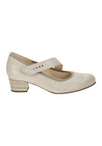 Beige leather Mary Jane shoe with a round toe, adjustable strap, and embellished with small silver studs. Low, textured block heel.